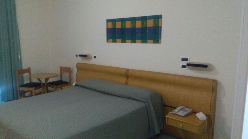Postel nebo postele na pokoji v ubytování Hotel Minerva