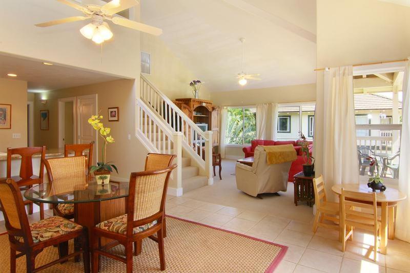 a living room with a table and a dining room at Regency at Poipu Kai #924 in Koloa