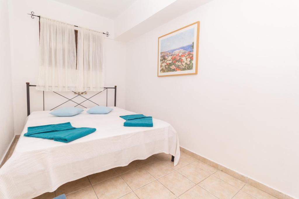 Postel nebo postele na pokoji v ubytování Alexger Psakoudia Seaview House