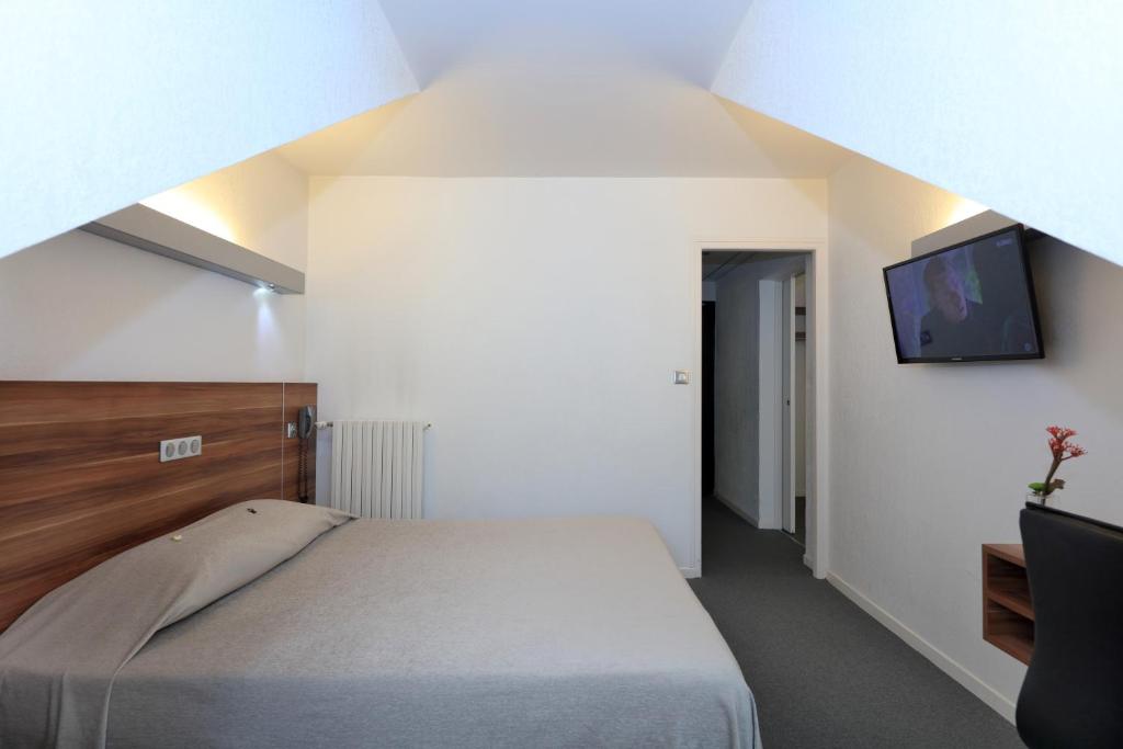 Postel nebo postele na pokoji v ubytování Logis Hôtel Restaurant L'Europe