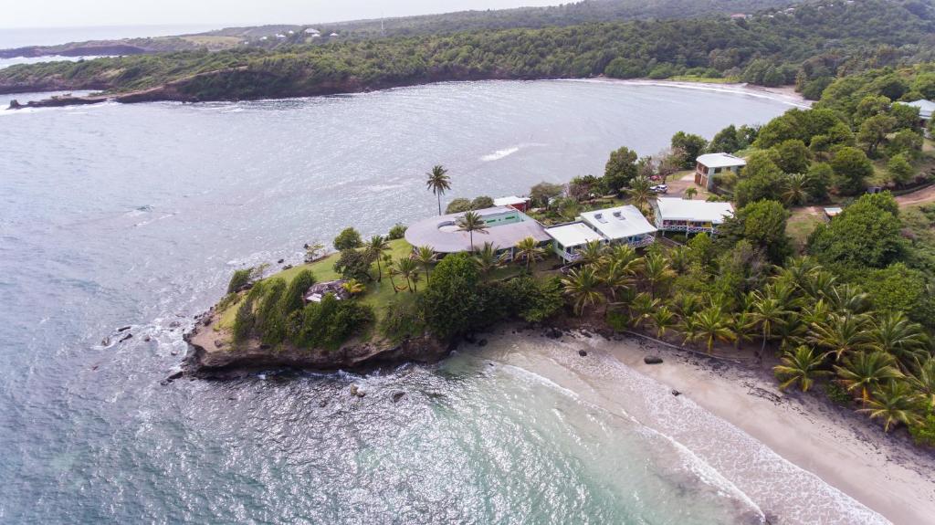 an aerial view of a house on an island in the ocean at Cabier Ocean Lodge in Crochu