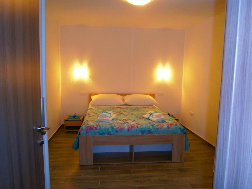 a small bedroom with a bed in a room at Room Vilma in Komiža