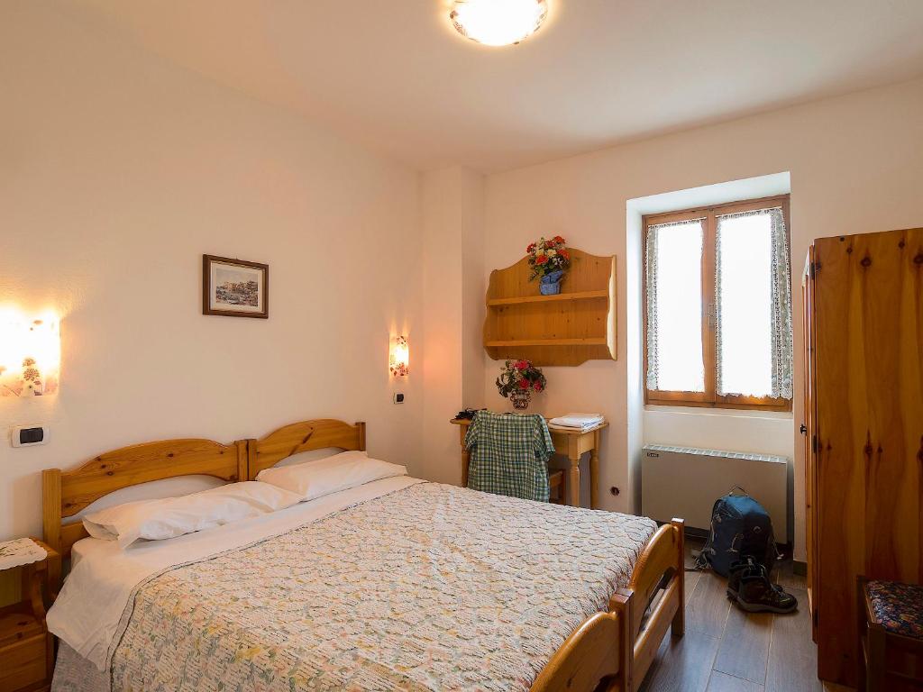 Postel nebo postele na pokoji v ubytování Rifugio Monte Baldo