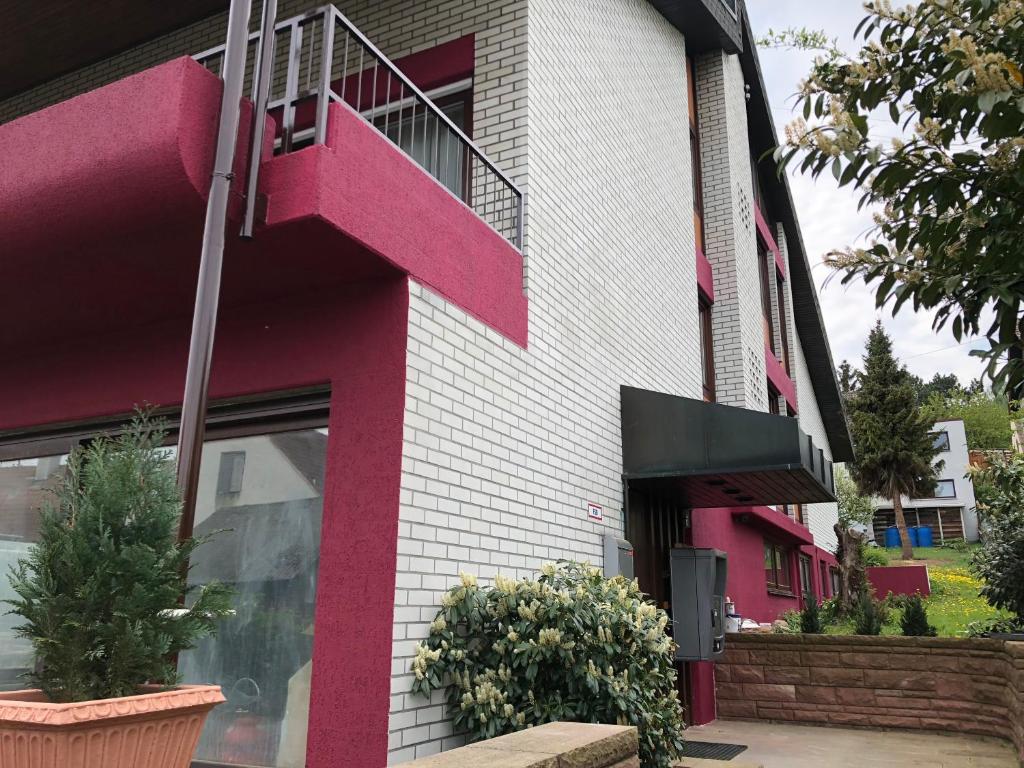 a pink and white building with a staircase at EC Hotel Elchingen in Elchingen