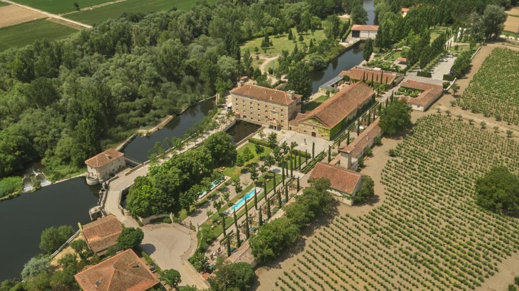 an aerial view of a mansion with a river at Hacienda Zorita Wine Hotel & Spa in Valverdón