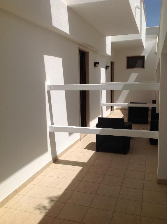 a room with white shelves and a tile floor at Hotel Corallo in Torre Santa Sabina