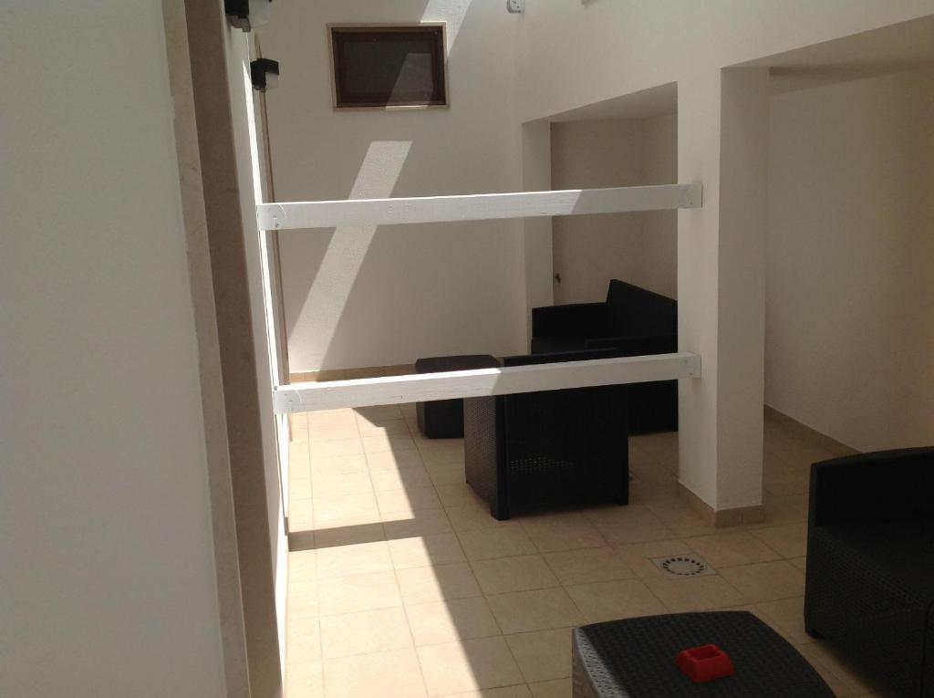 a room with two bunk beds and a piano at Hotel Corallo in Torre Santa Sabina