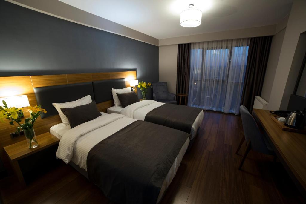 Postel nebo postele na pokoji v ubytování MD Barbaros Hotel