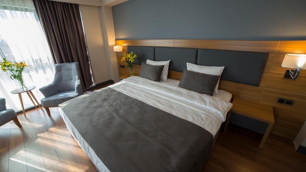 Postel nebo postele na pokoji v ubytování MD Barbaros Hotel