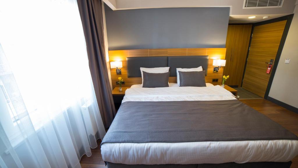 Postel nebo postele na pokoji v ubytování MD Barbaros Hotel