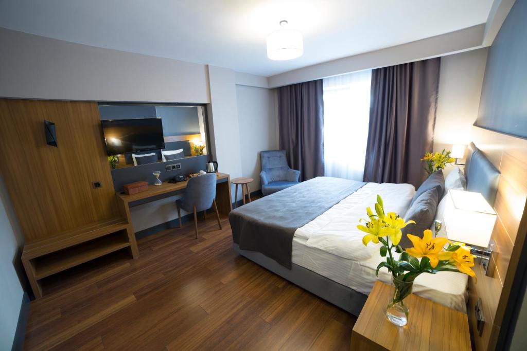 Postel nebo postele na pokoji v ubytování MD Barbaros Hotel