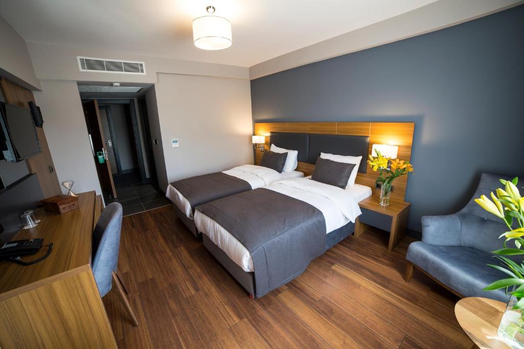 Postel nebo postele na pokoji v ubytování MD Barbaros Hotel