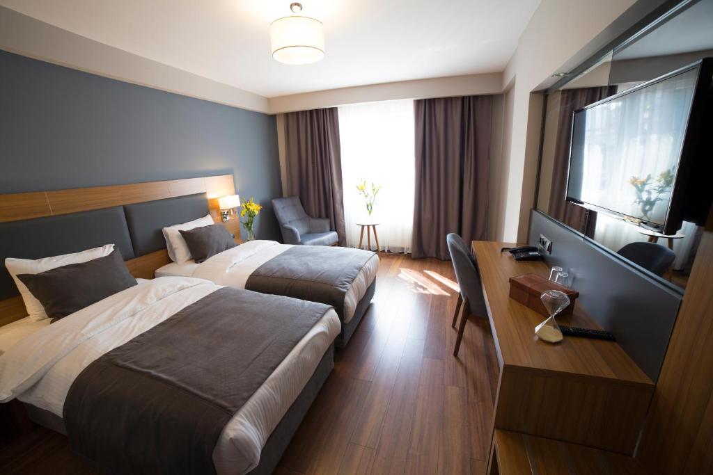 Postel nebo postele na pokoji v ubytování MD Barbaros Hotel