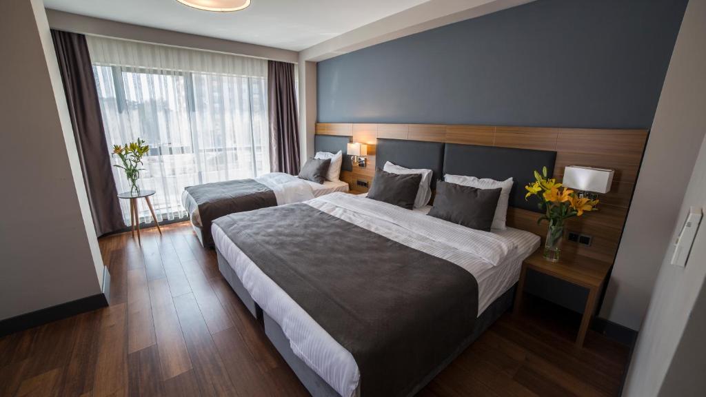 Postel nebo postele na pokoji v ubytování MD Barbaros Hotel