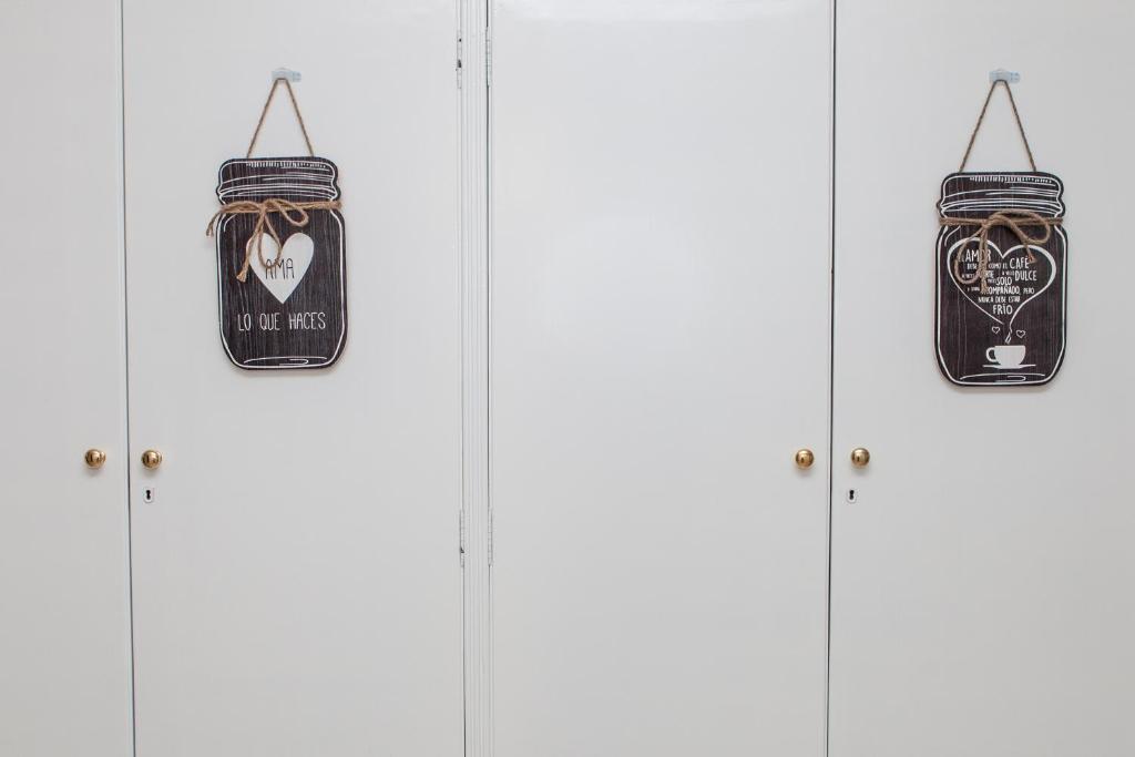 a group of four doors with signs on them at Los Rosales in Sarón
