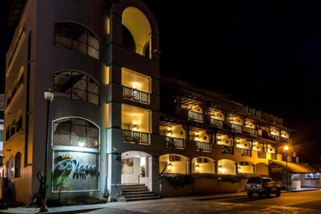 a large building with lights on it at night at Hotel Blater in Puerto Escondido