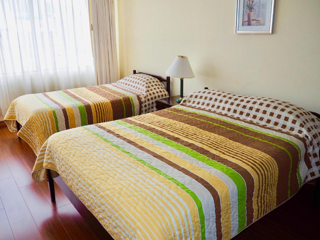 Postel nebo postele na pokoji v ubytování Hotel 6 De Diciembre