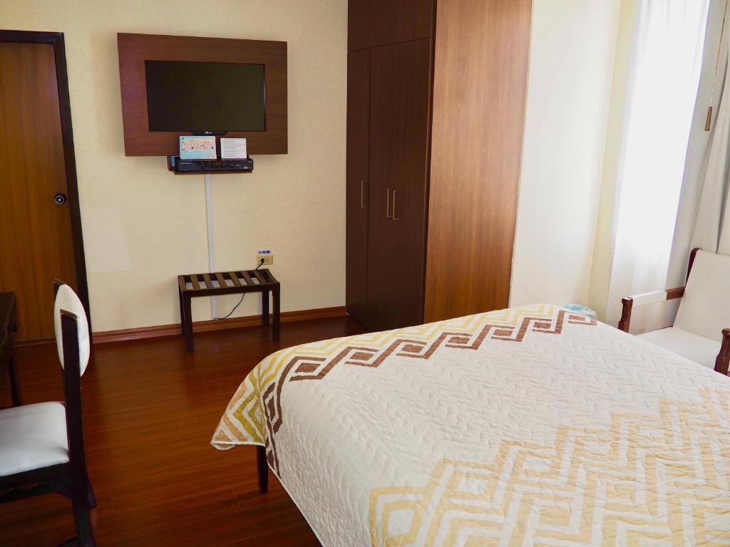 Postel nebo postele na pokoji v ubytování Hotel 6 De Diciembre