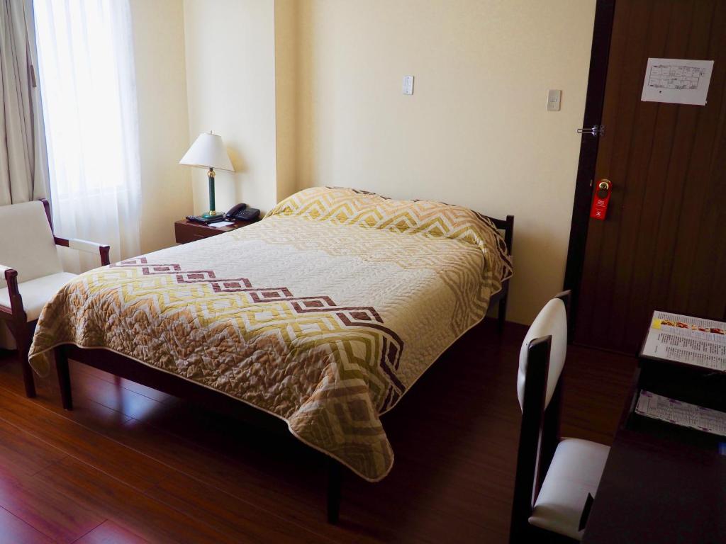 Postel nebo postele na pokoji v ubytování Hotel 6 De Diciembre