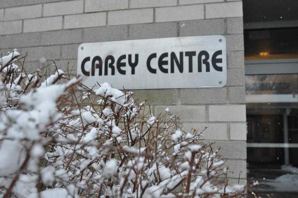 a sign for a garage centre in the snow at Carey Centre on UBC campus in Vancouver