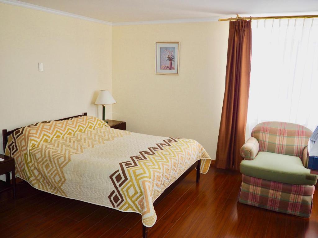 Postel nebo postele na pokoji v ubytování Hotel 6 De Diciembre