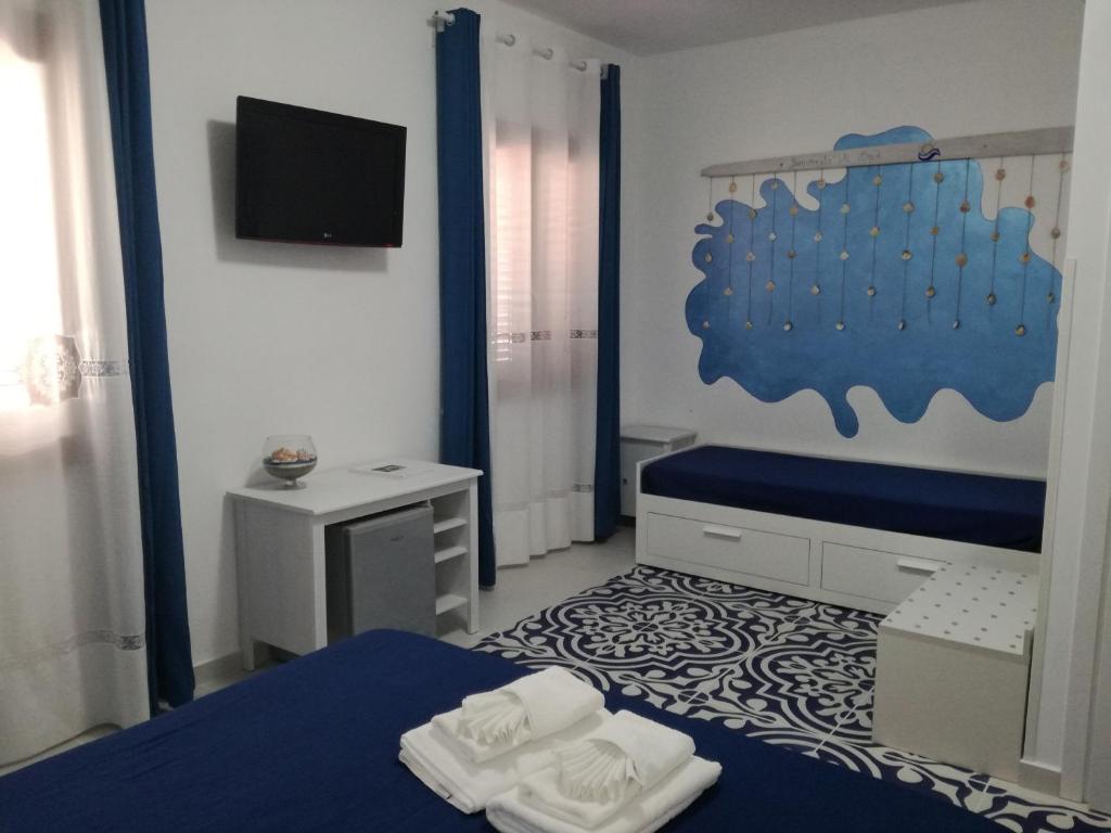 a bedroom with a bed and a tv in it at Benvenuti al Sud B&B in Macari