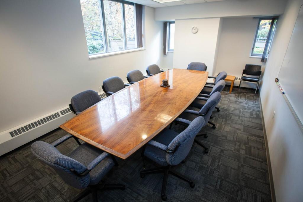 a conference room with a wooden table and chairs at Carey Centre on UBC campus in Vancouver