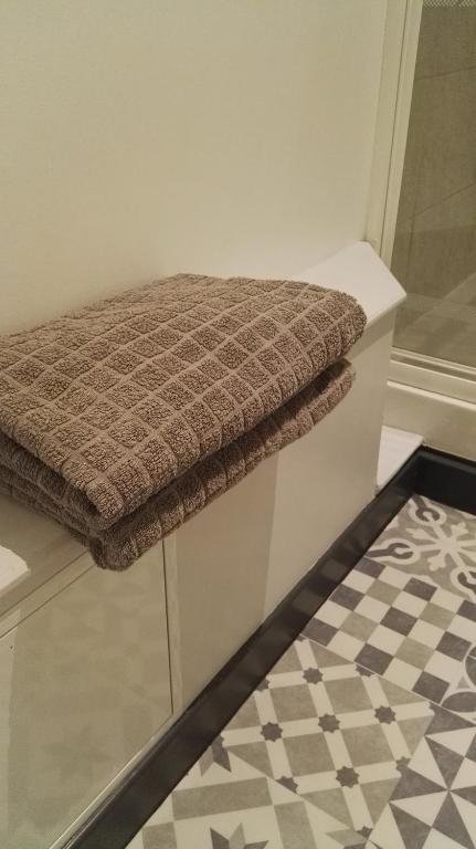 a bench in a bathroom with a checkered floor at Résidence de Vaux in Nans-sous-Sainte-Anne
