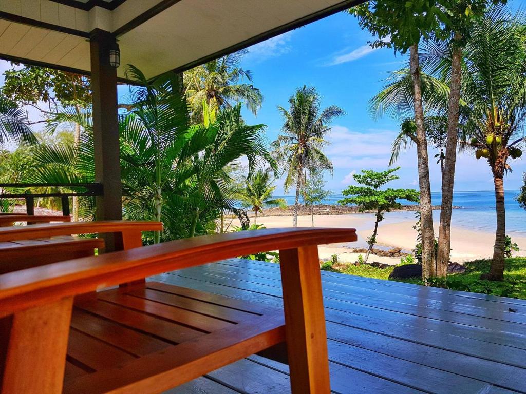 a wooden deck with a view of the beach at S Beach Resort in Ko Kood