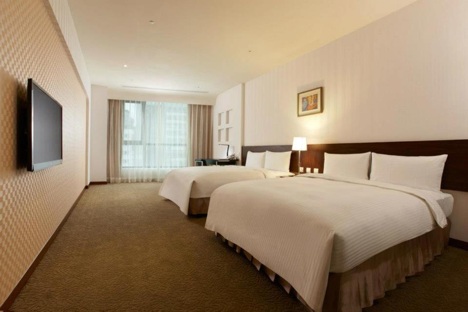 Postel nebo postele na pokoji v ubytování Taisugar Hotel Taipei