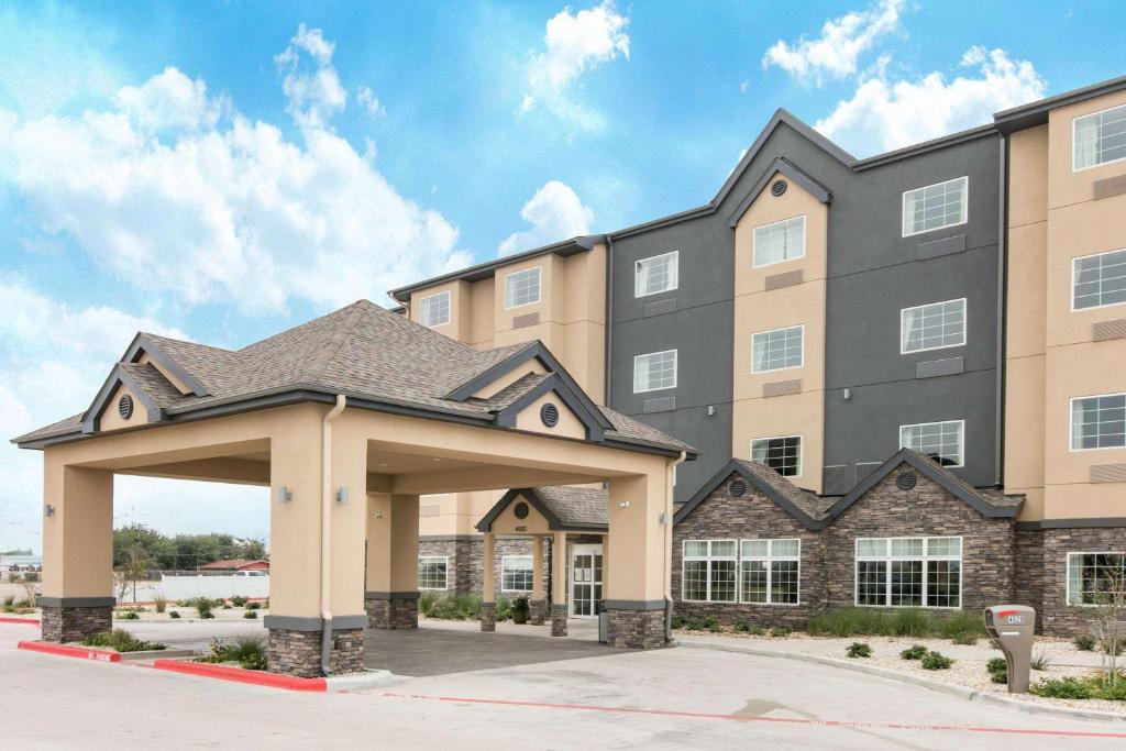 a large building with a clock on the front of it at Microtel Inn and Suites by Wyndham Lubbock in Lubbock