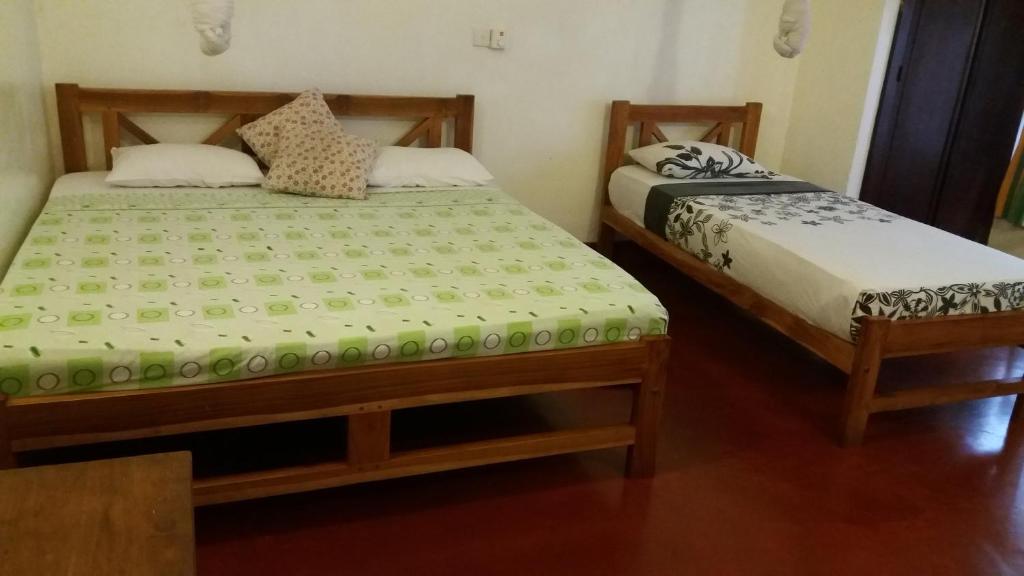 Postel nebo postele na pokoji v ubytování Hotel Mango Garden