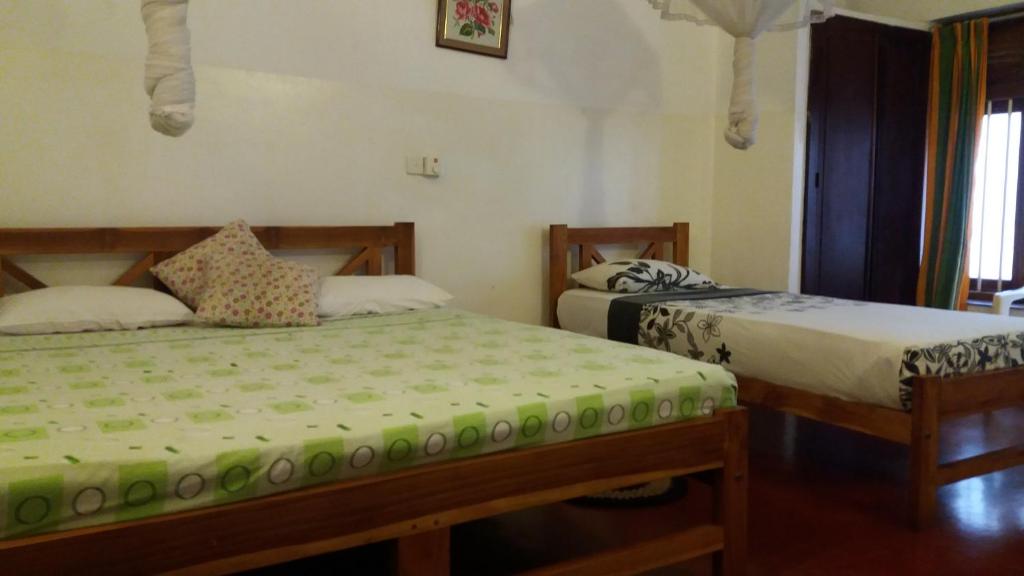 Postel nebo postele na pokoji v ubytování Hotel Mango Garden