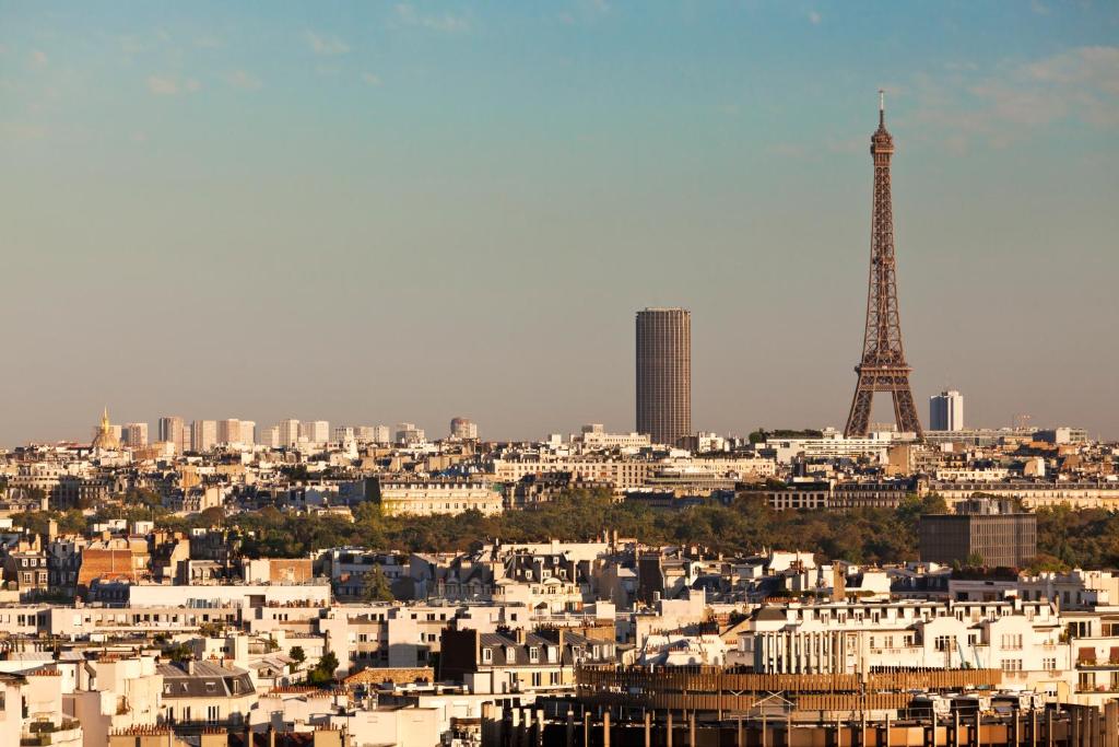 a view of a city with the eiffel tower at ibis Styles Paris Boulogne Marcel Sembat in Boulogne-Billancourt