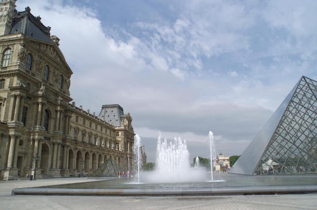 a fountain in front of a building with a clock tower at ibis Styles Paris Boulogne Marcel Sembat in Boulogne-Billancourt
