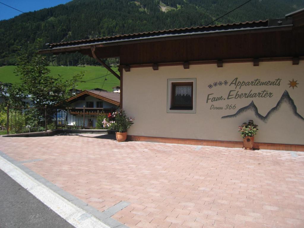 a building with a sign on the side of it at Appartements Familie Eberharter in Finkenberg