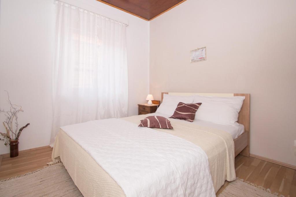 Postel nebo postele na pokoji v ubytování Apartmani Vela Luka