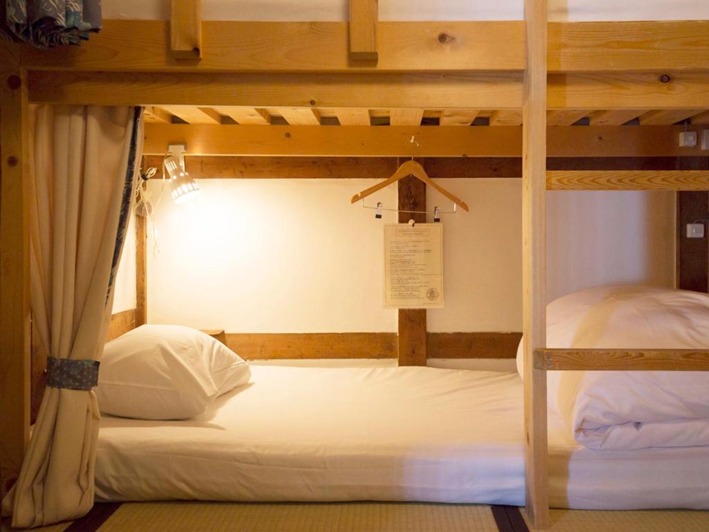 Postel nebo postele na pokoji v ubytování Guest House Pongyi