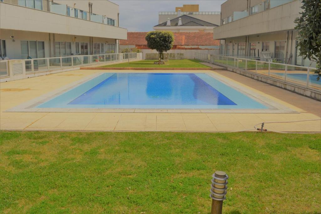 a large swimming pool in the middle of a building at Porto Sea Front Apartment in Lavra