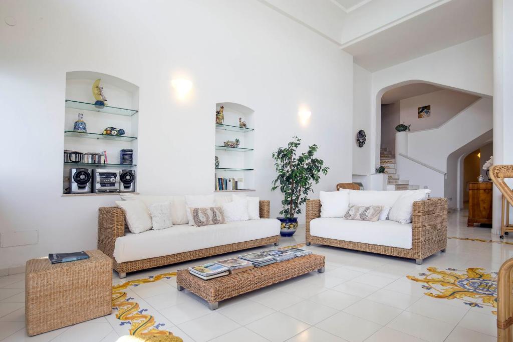 a living room with two couches and a coffee table at Casa dei Limoni in Erchie