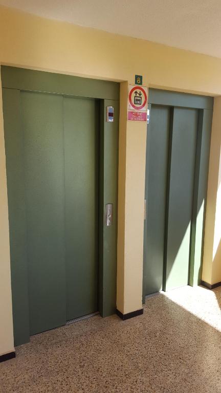 a row of three green stalls in a building at Torres del Sol Playa de Las Vistas FREE WIFI in Playa de las Americas