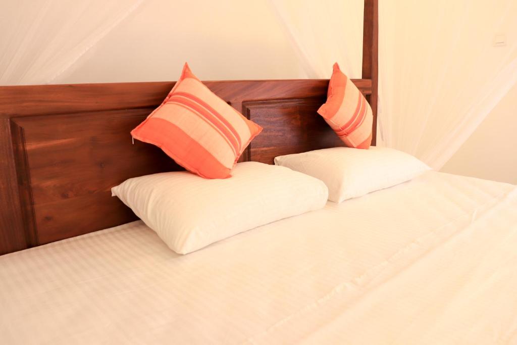 Postel nebo postele na pokoji v ubytování Welcome Inn Mirissa