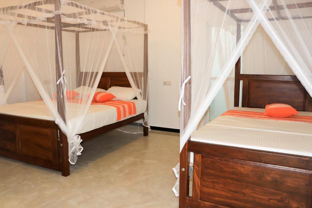 Postel nebo postele na pokoji v ubytování Welcome Inn Mirissa