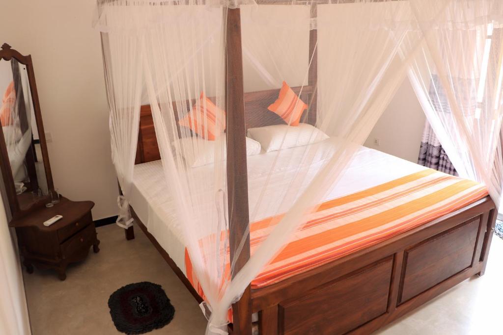 Postel nebo postele na pokoji v ubytování Welcome Inn Mirissa