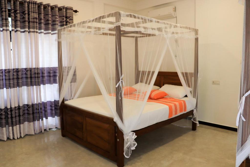 Postel nebo postele na pokoji v ubytování Welcome Inn Mirissa