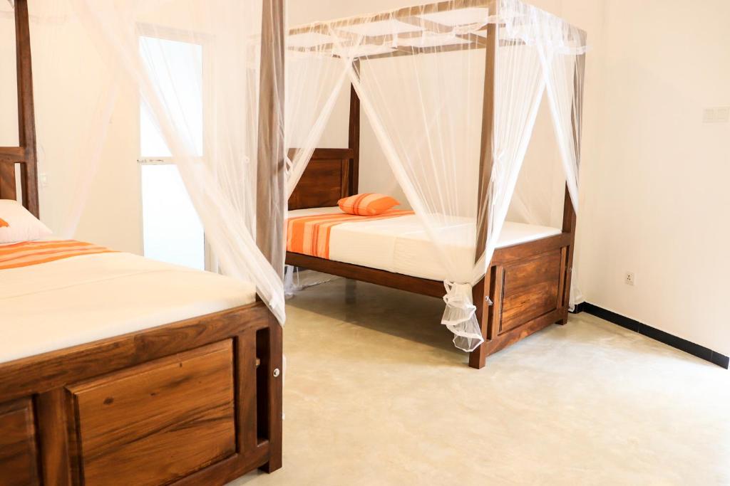 Postel nebo postele na pokoji v ubytování Welcome Inn Mirissa