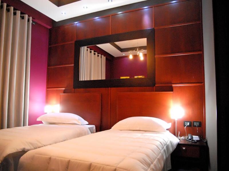Postel nebo postele na pokoji v ubytování Icon Hotel