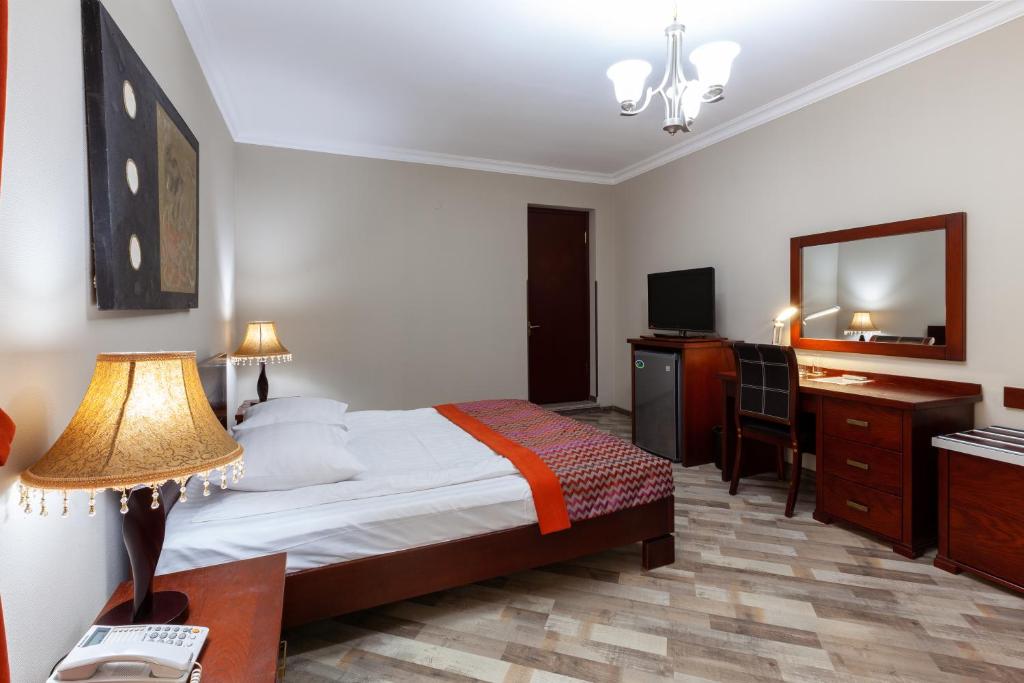 Postel nebo postele na pokoji v ubytování Penthouse Hotel