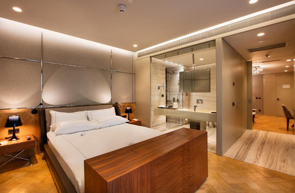 a bedroom with a large bed and a bathroom at Fer Hotel in Istanbul