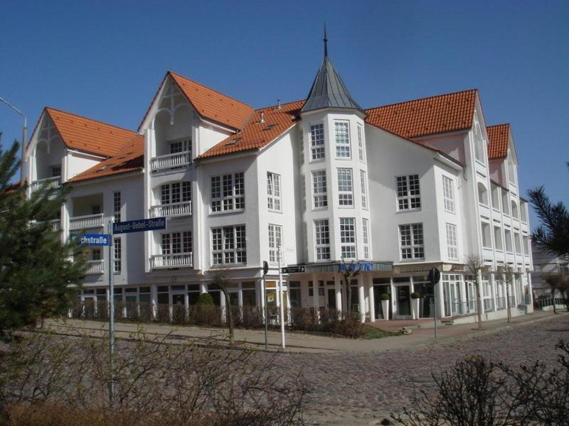 a large white building with a red roof at Haus Baltic in Ostseebad Sellin